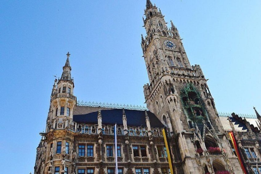 A historic building with two prominent towers and a clock. 2