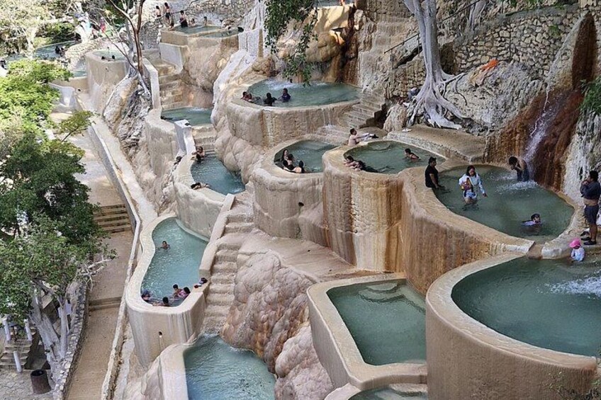 Terraced hot springs with people relaxing. 1