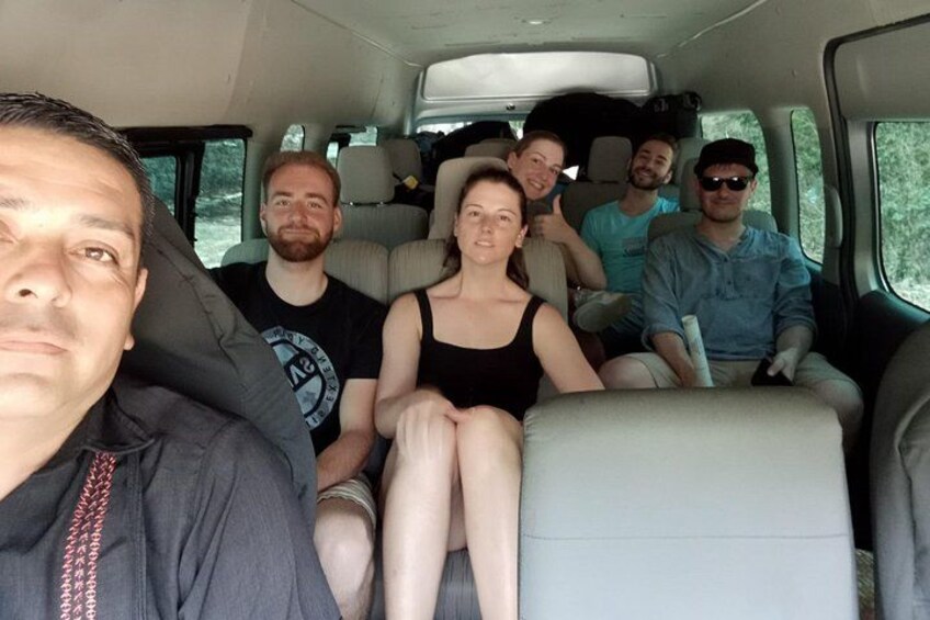 A group of people seated inside a vehicle. 5