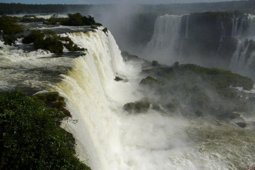 A large waterfall with multiple cascades, surrounded by lush greenery. 2