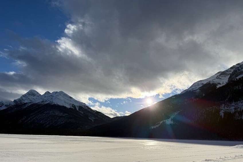 A snow-covered mountain range with a clear sky and sunlight. 2