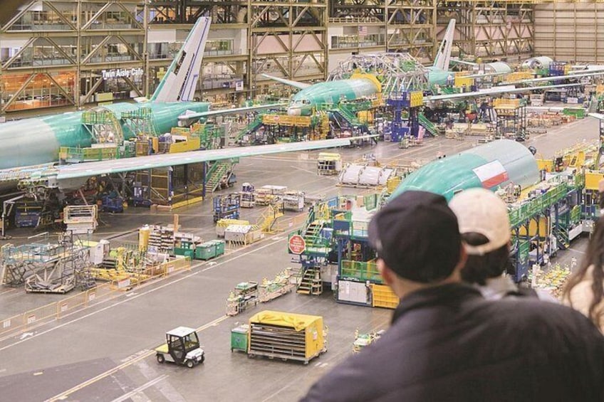 An airplane assembly line with multiple aircraft in various stages of construction. 3