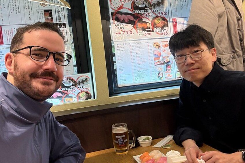 Dos personas sentadas en una mesa con un menú y una jarra de cerveza. 3