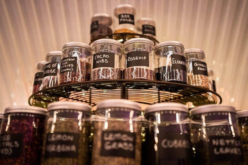 A display of various jars with labels such as 'Mountain Rose', 'Cacao Nibs', and 'Rosehip'. 5