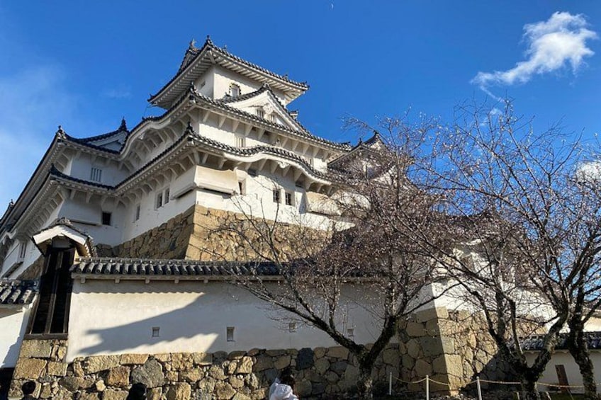 A traditional Japanese castle with multiple tiers and a stone base. 5