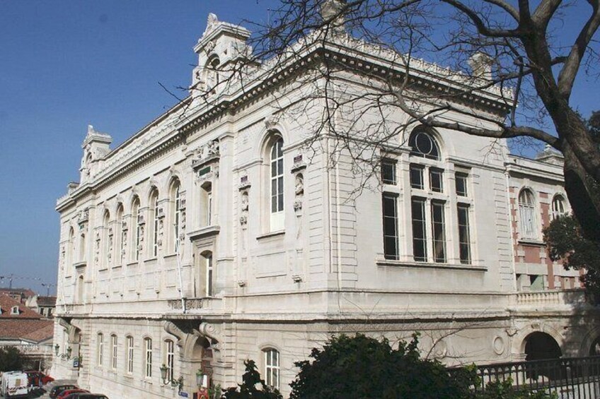 A classical building with arched windows and a symmetrical facade. 2
