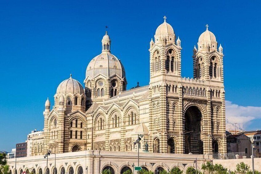 A large, ornate cathedral with multiple domes and towers, featuring intricate architectural details and a prominent arched entrance. 4