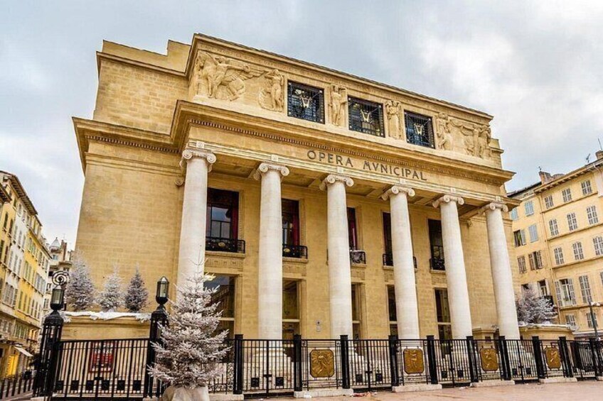 The exterior of the Opera Avincipal building with classical architecture, including columns and decorative sculptures. 3