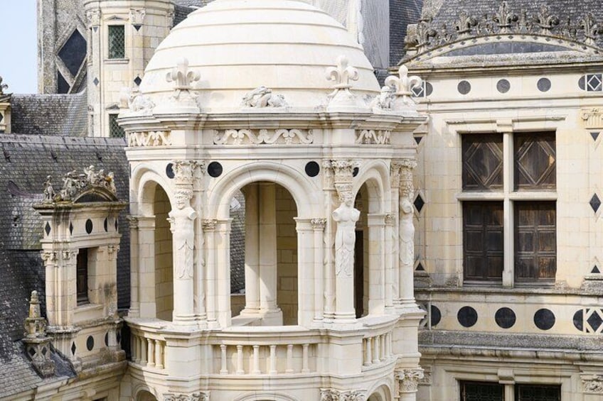 A detailed architectural structure with ornate carvings and a dome. 2