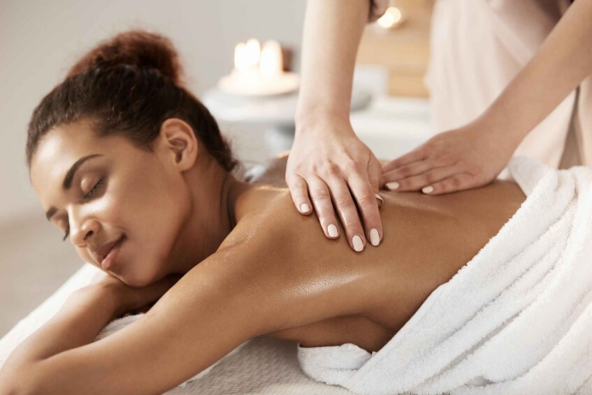 A person receiving a back massage. 2