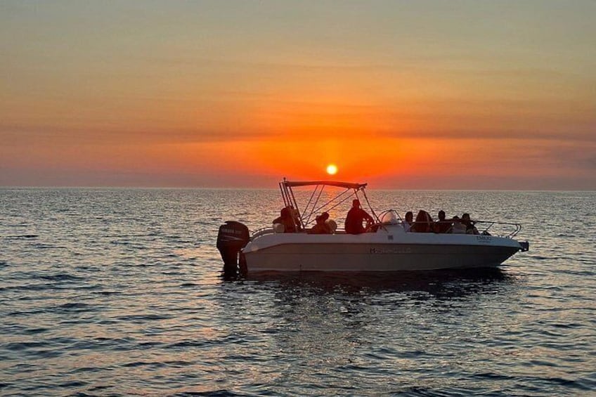 A boat on calm water during sunset. 3