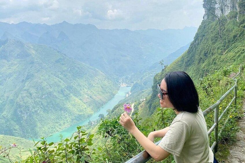A person taking a photo of a river and mountains. 2