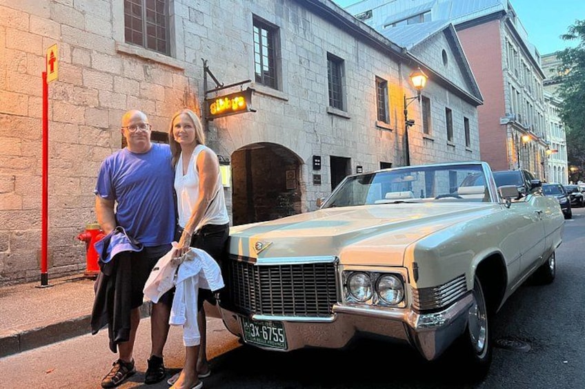 A vintage car parked on a street with a building in the background. 2