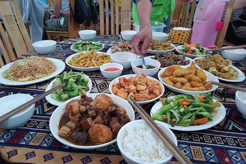 A table with various dishes including rice, vegetables, and meat. 4