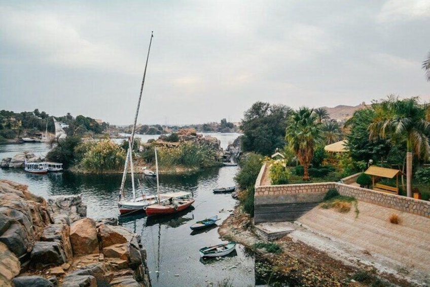 A river with boats, a stone bridge, and greenery. 5