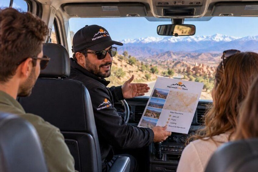 A person in a vehicle holding a map, with a mountainous landscape visible through the window. 3