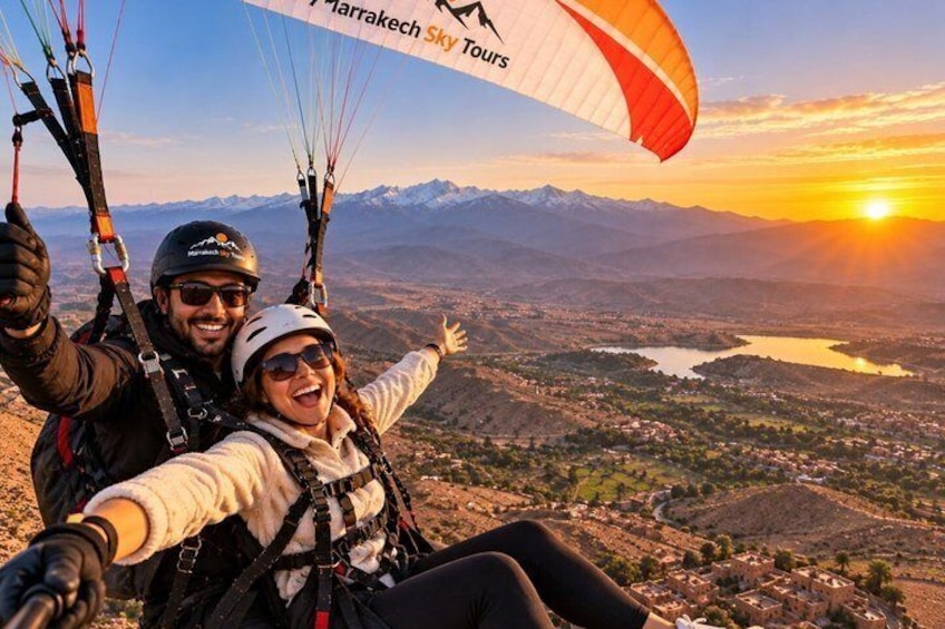 A person paragliding with a parachute, a mountainous landscape, and a sunset in the background. 1