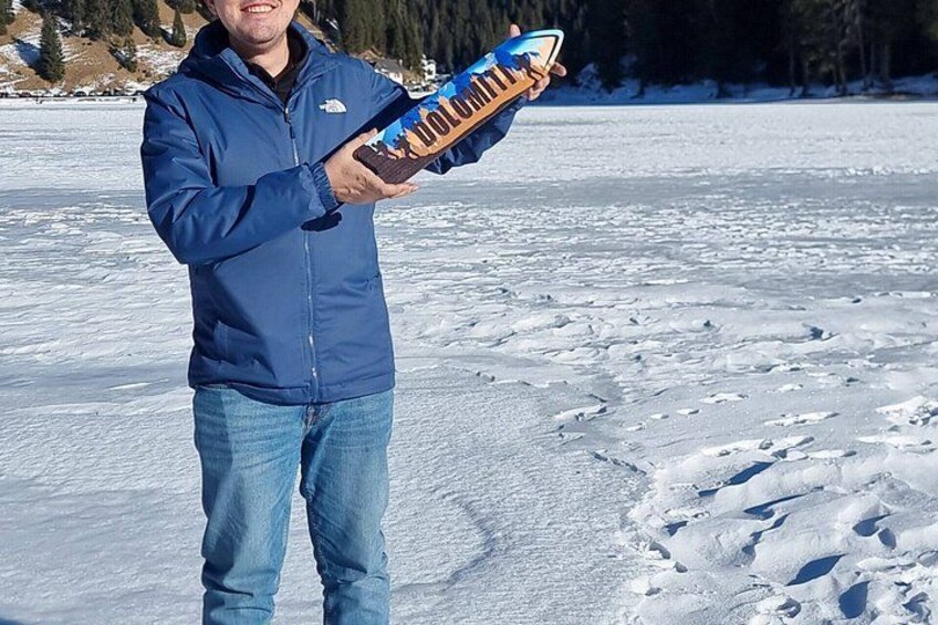 Una persona tiene uno snowboard su una superficie innevata. 2