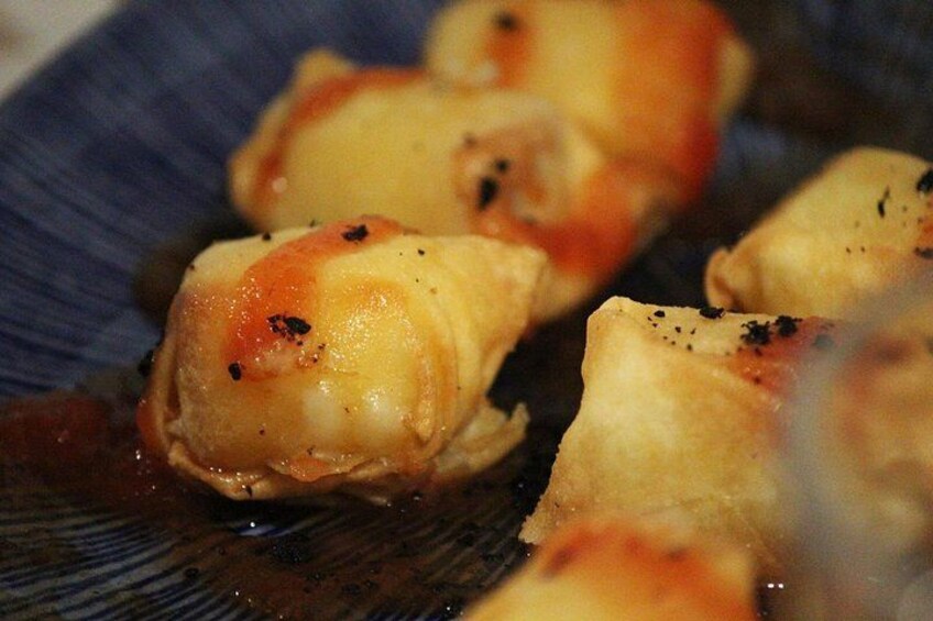 A close-up of food items, possibly pastries, on a blue plate. 5