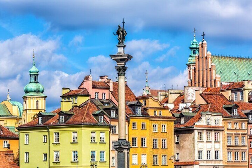 A historic European cityscape with colorful buildings and a prominent monument. 4