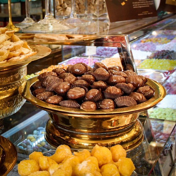 A display of assorted chocolates and sweets in a glass case. 4