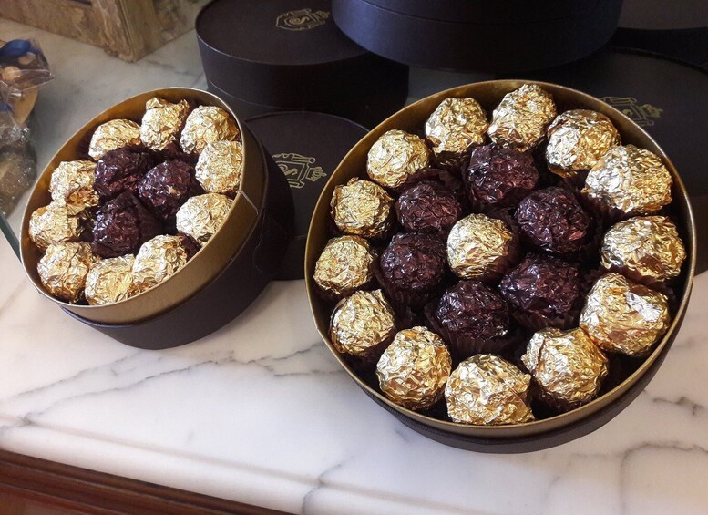 Two bowls of chocolates on a marble countertop. 3