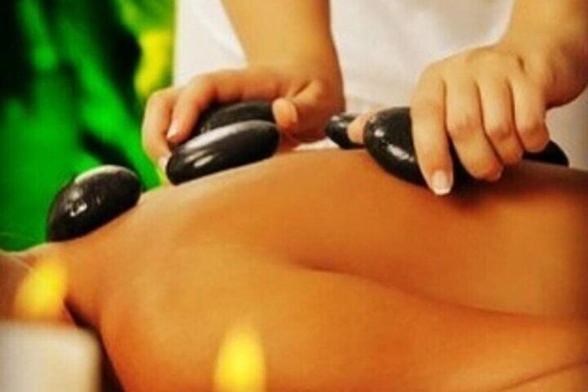 A person receiving a hot stone massage. 5