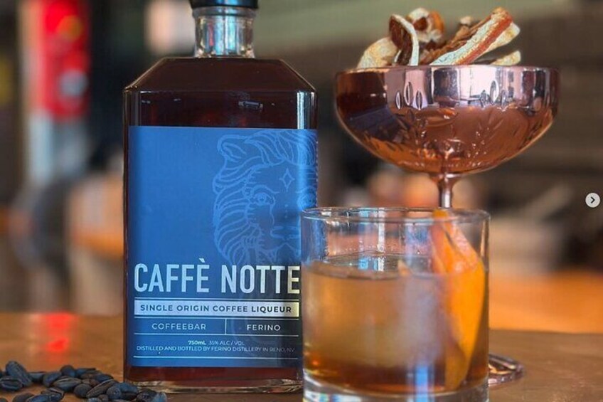 A bottle of Caffè Notte coffee liqueur, a glass of coffee liqueur, and a cocktail with a metal bowl. 3