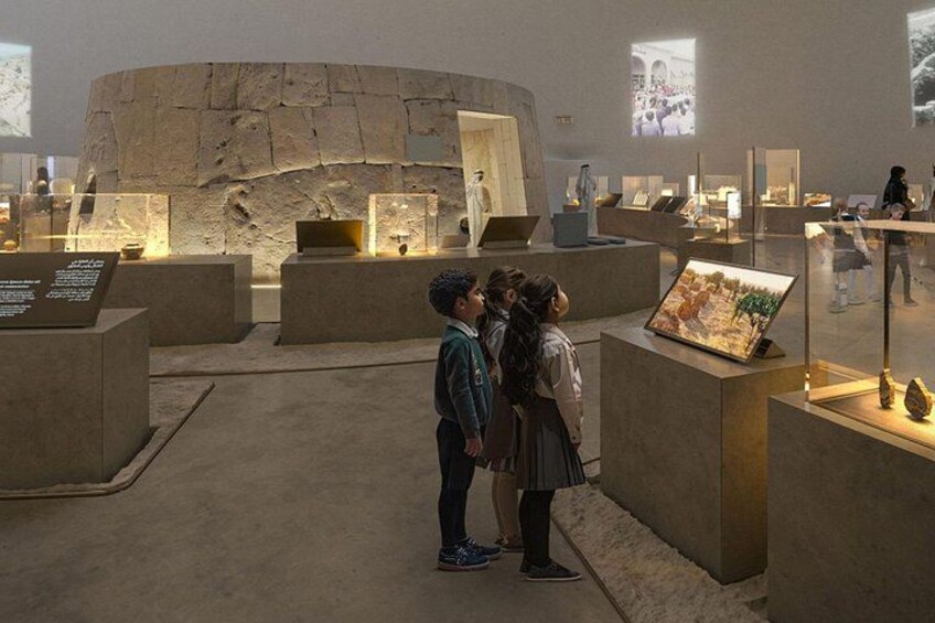 An indoor exhibition with stone structures and displays. 4