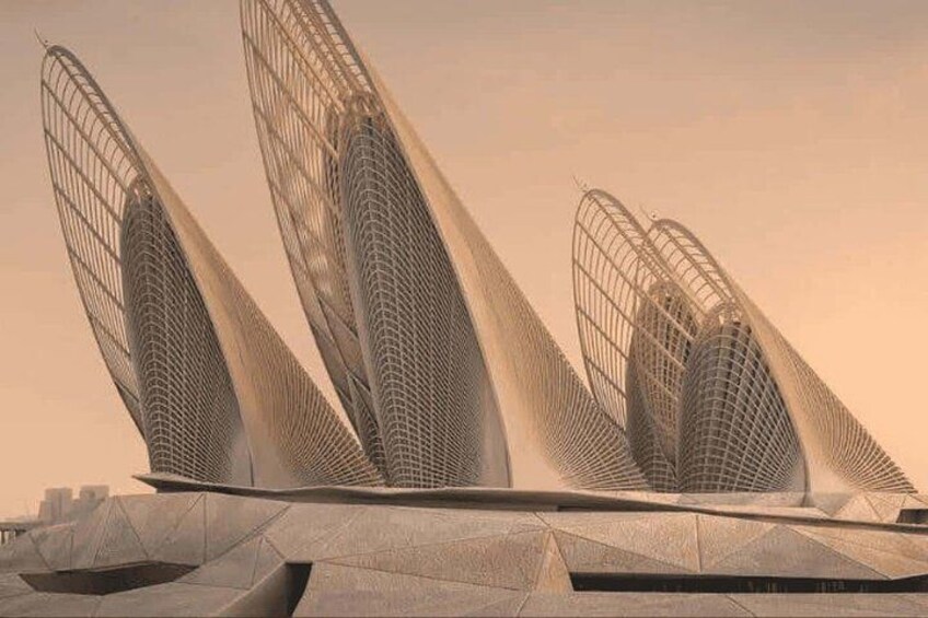 A modern architectural structure with three prominent, curved, metallic towers. 1