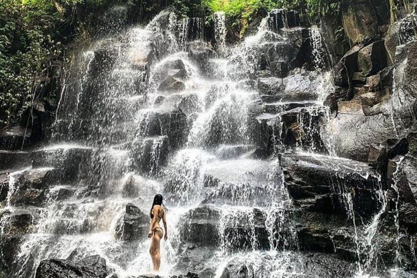 A waterfall with multiple streams cascading over rocks. 1