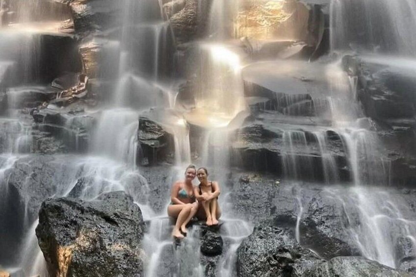 A waterfall with multiple streams cascading over rocks. 3