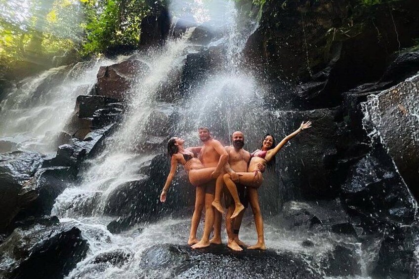 A waterfall with people enjoying the water. 4