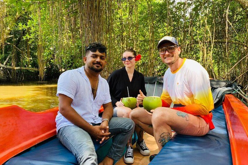 Three people sitting on a boat in a forested area. 1