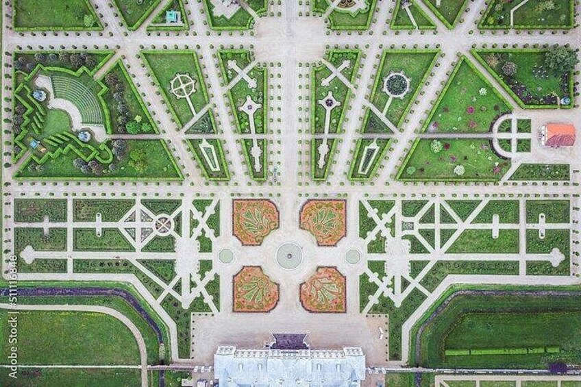 A detailed layout of a formal garden with symmetrical pathways, fountains, and statues. 4
