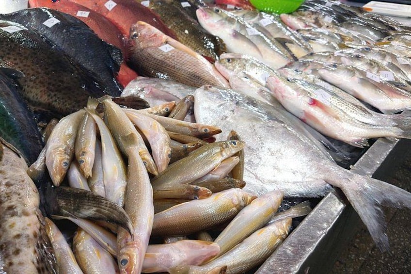 A variety of fresh fish displayed at a market. 2