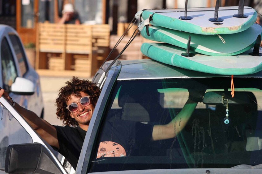 A car with surfboards on the roof. 1