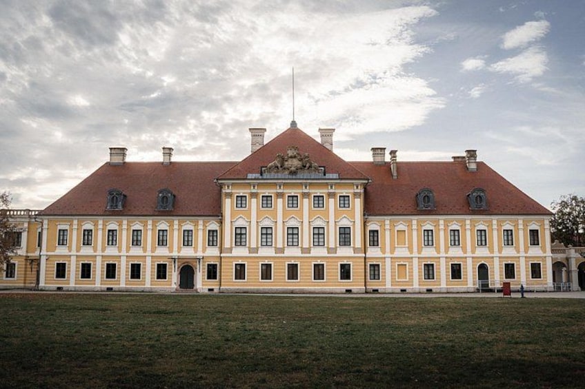 A large, historic building with a symmetrical facade, multiple windows, and a central entrance. 4