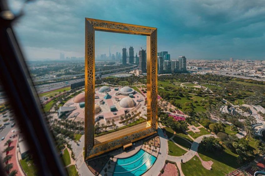 A large golden frame with a cityscape in the background. 1