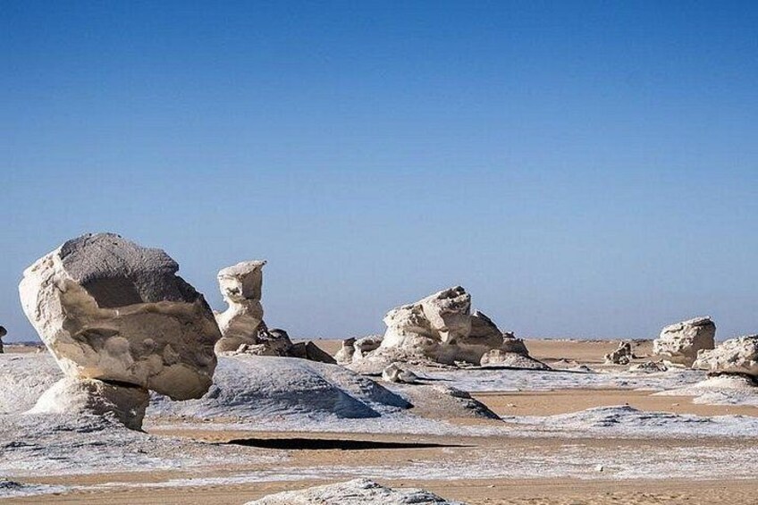 A desert landscape with large rock formations. 5