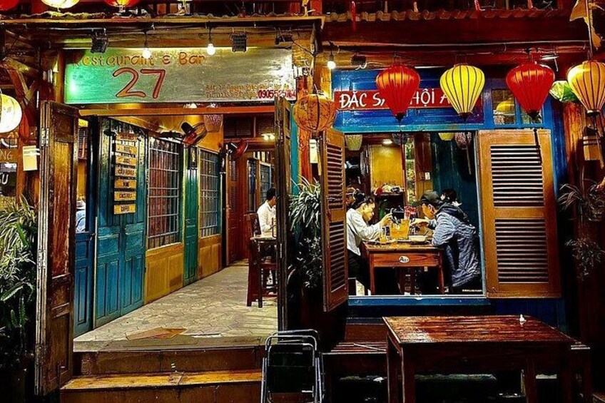 A traditional Vietnamese restaurant with a sign reading 'Restaurant Bar 27' and 'Dac Sao Ai'. 4