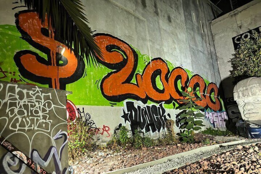 A wall with graffiti, including the word '2cool4u' in orange and black. 3