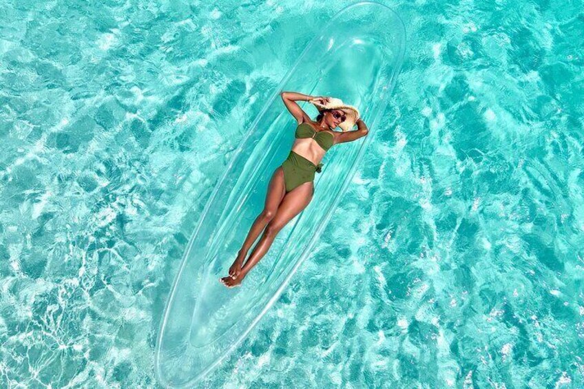 A person floating on a clear water surface. 3