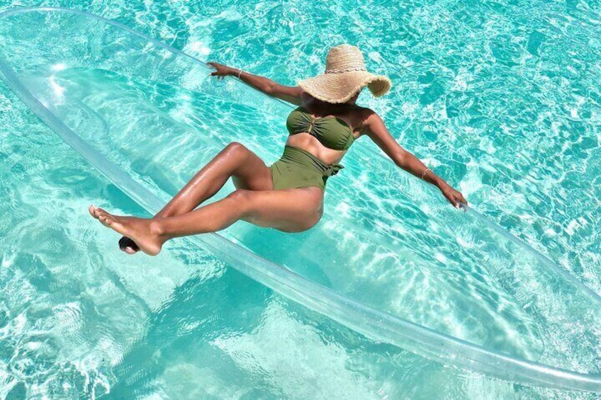 A person floating on a clear water surface in a swimming pool. 4