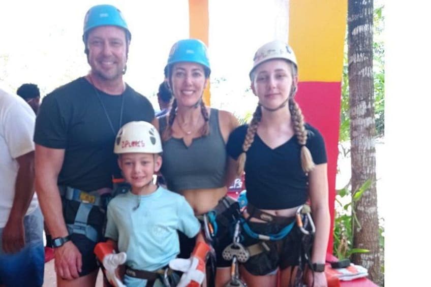 A family with helmets and harnesses, suggesting a climbing or rappelling activity. 1