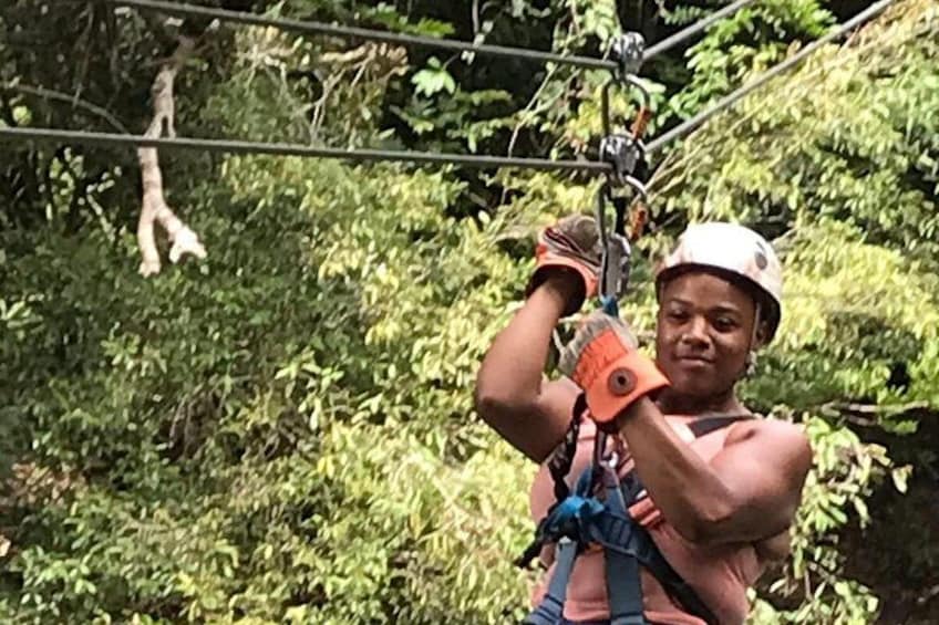 A person zip-lining through a forested area. 3
