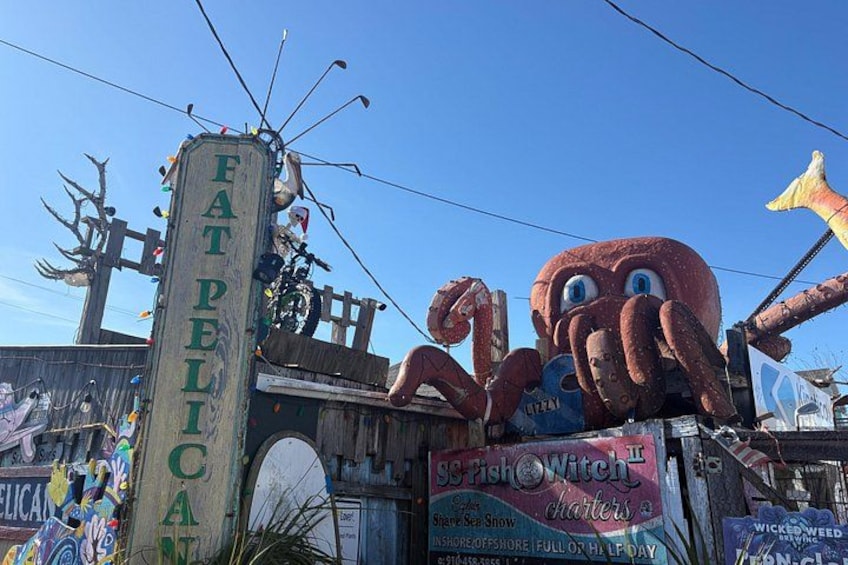 A large octopus statue, a sign reading 'Fat Pelican,' and a 'SC Fish Witch' sign. 4