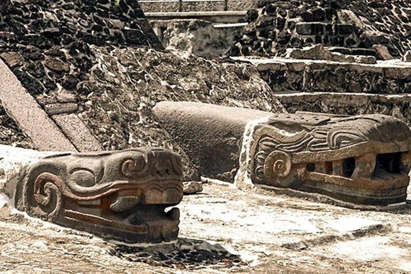 Ancient stone carvings, possibly of mythical creatures, in a historical site with stone steps and ruins. 5