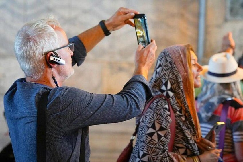 A person taking a photo with a smartphone. 3