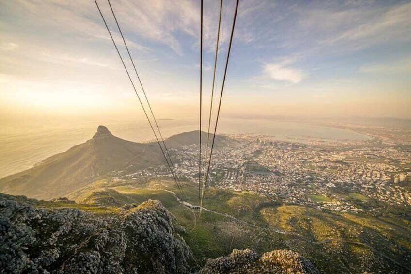A cable car overlooking a cityscape with a prominent mountain in the background. 5